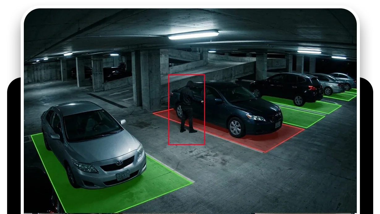 A parking lot with each vehicle outlined, one person at the entrance and one car flagged in red